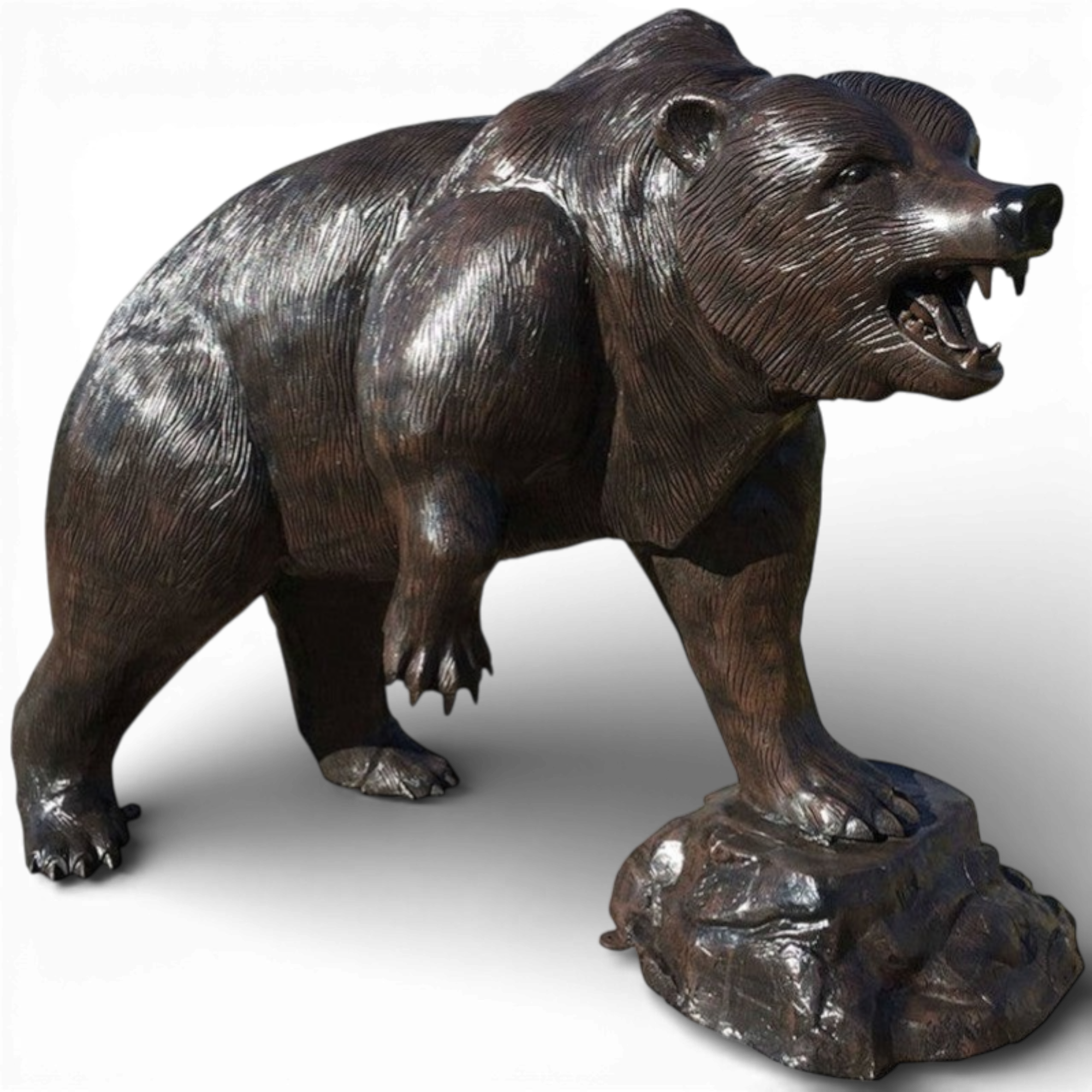 Large grizzly bear sculpture cast aluminum statue on rock base isolated on white background