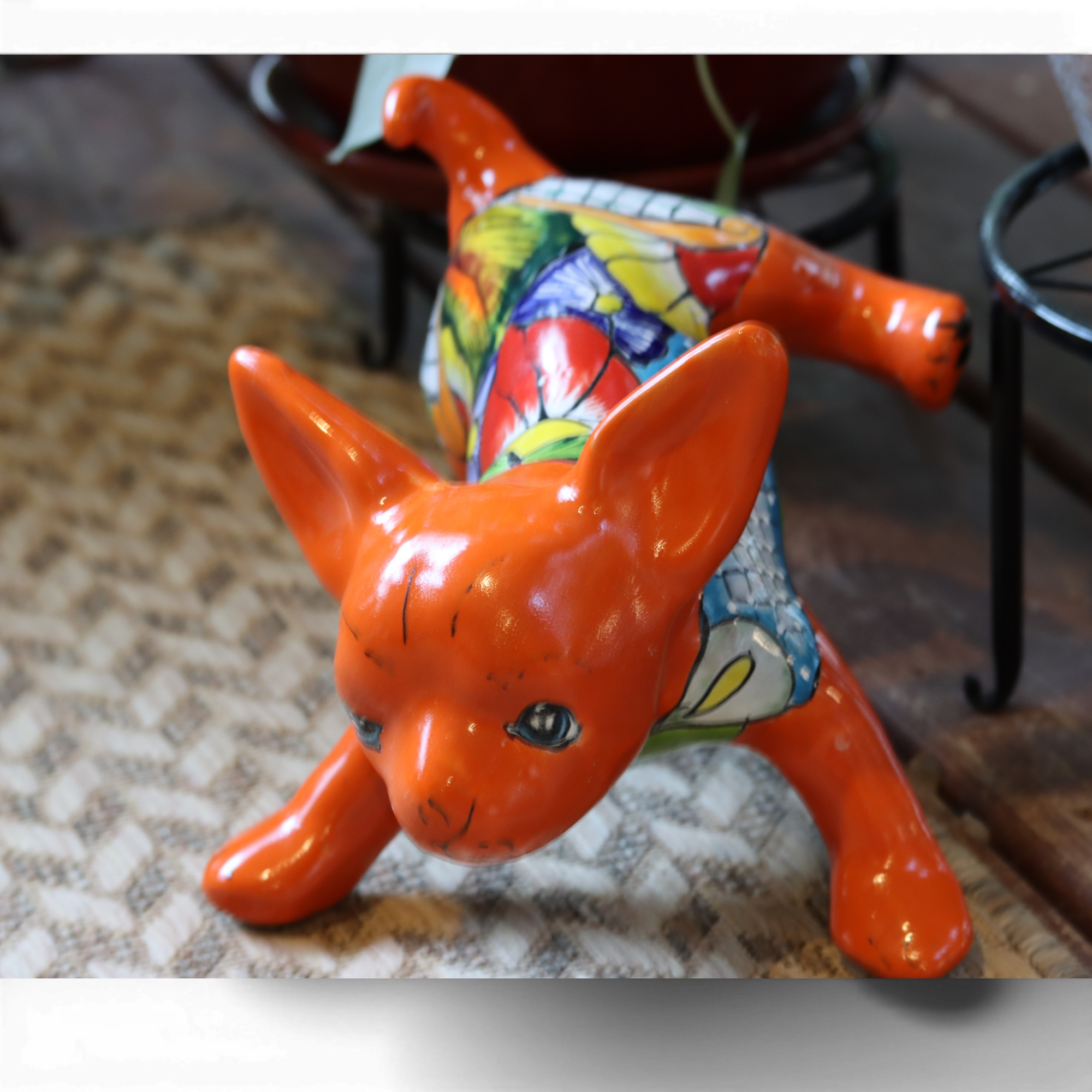Hand painted Talavera chihuahua figurine with colorful Mexican ceramic design displayed in a home setting