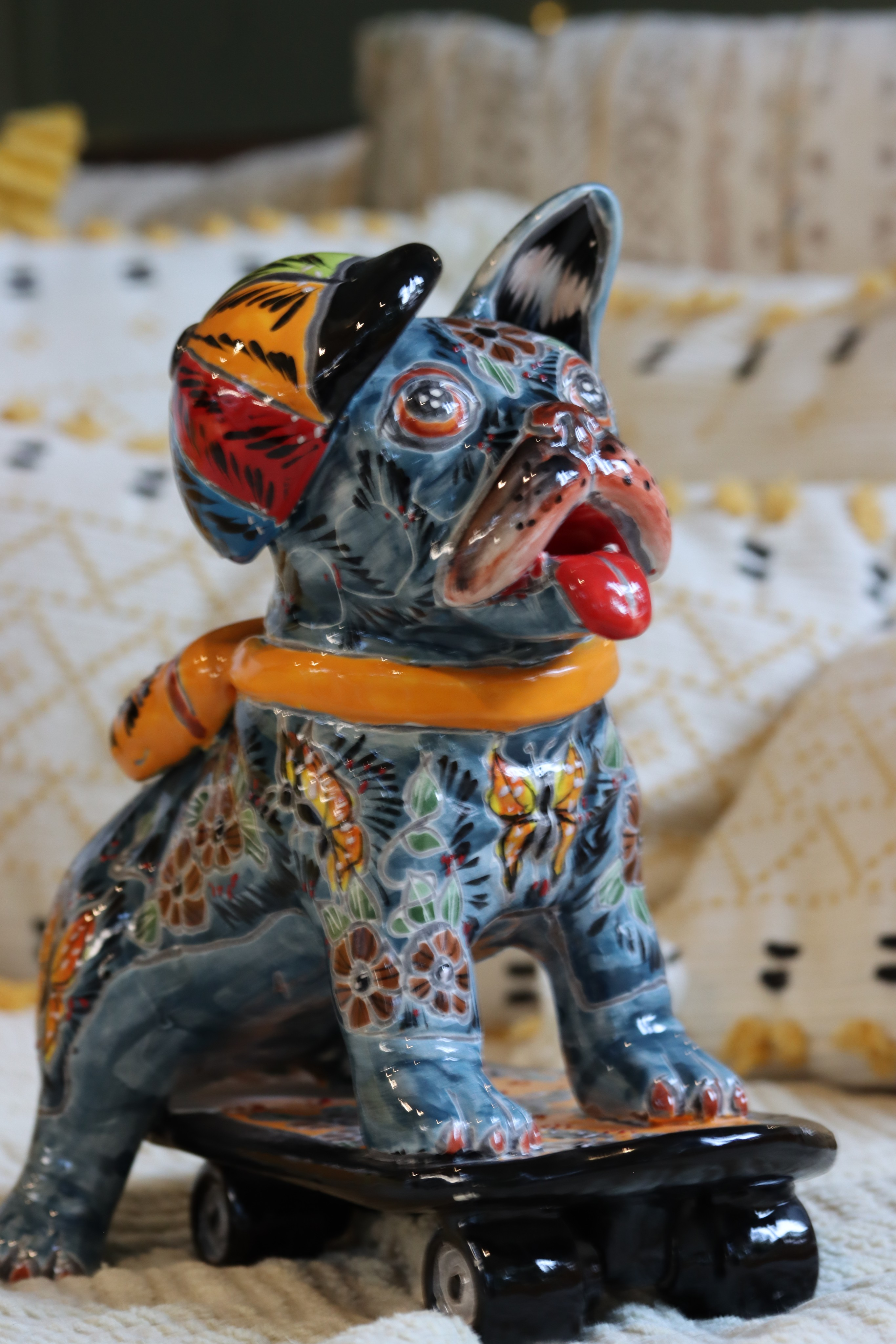 Talavera French bulldog figurine on skateboard hand painted Mexican ceramic decor on sofa